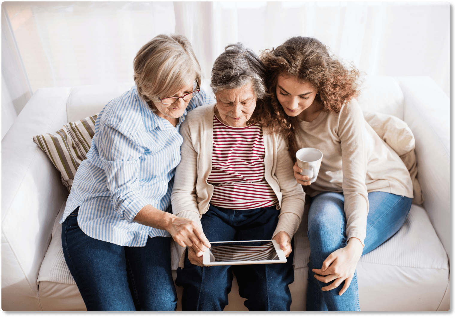 A family gathered together looking at a tablet